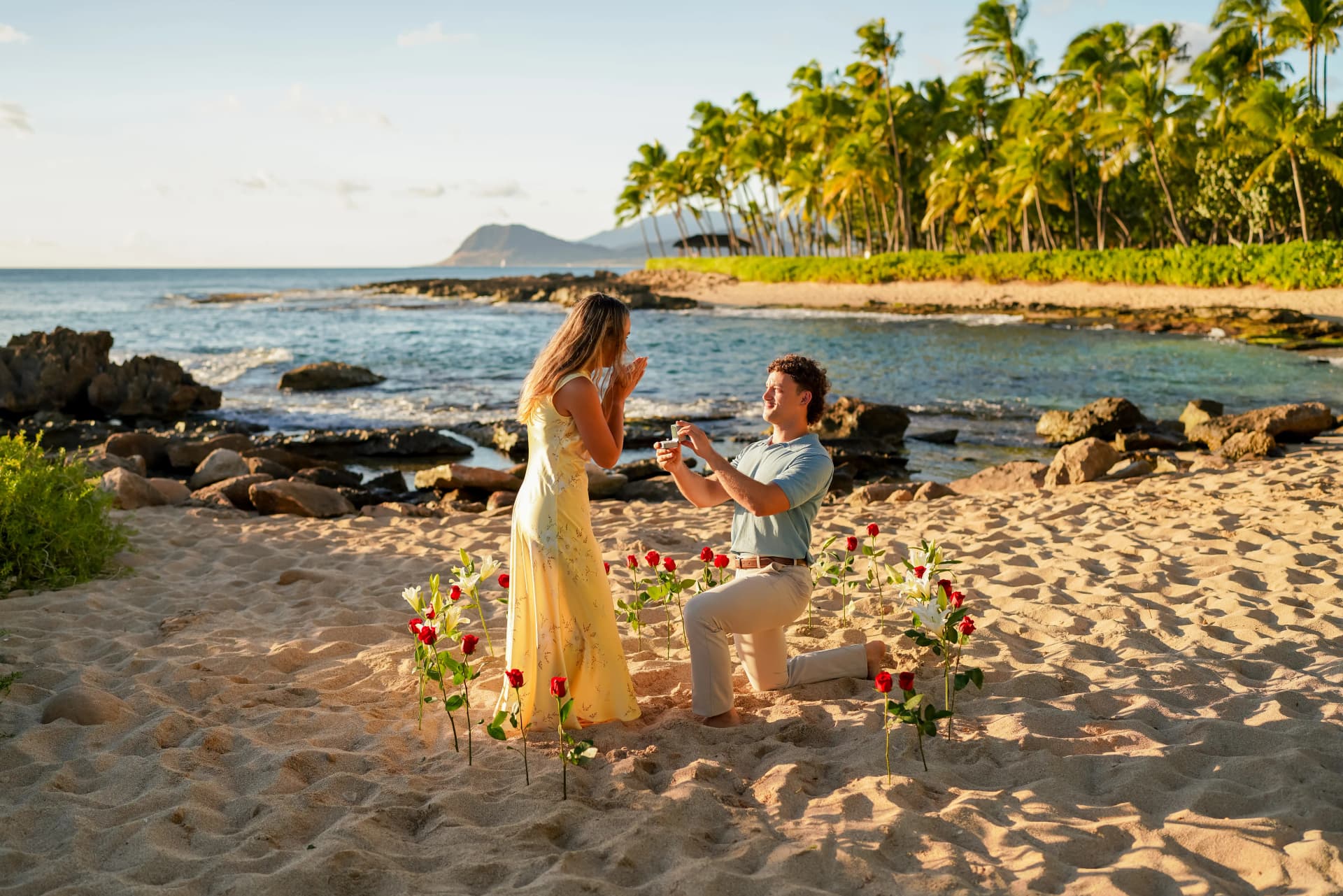 Beach proposal with roses at sunset in Hawaii